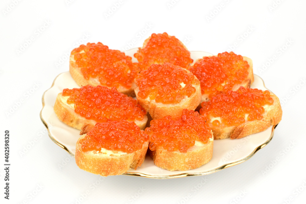 Sandwiches with red caviar laid out on a white plate