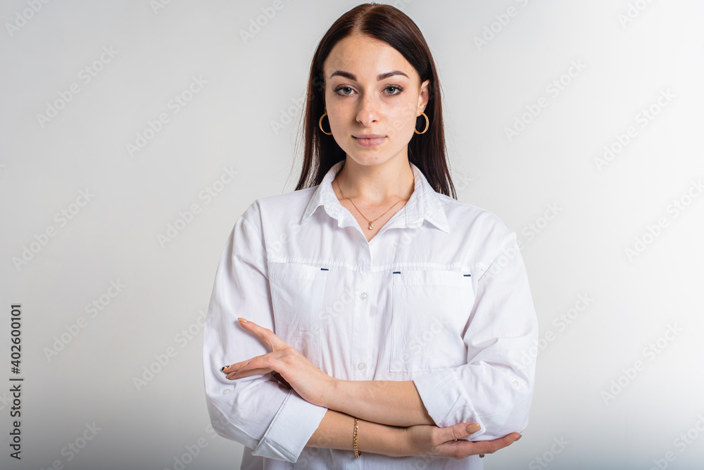 close up portrait, young, nice, attractive, lovely pretty cheerful girl with folded arms isolated over light white background of pastel colors close up portrait, young, nice, attractive, lovely pretty cheerful girl with folded arms isolated over light white background of pastel colors
