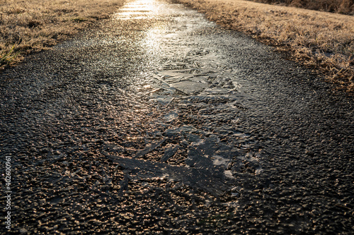 Paved path with black ice