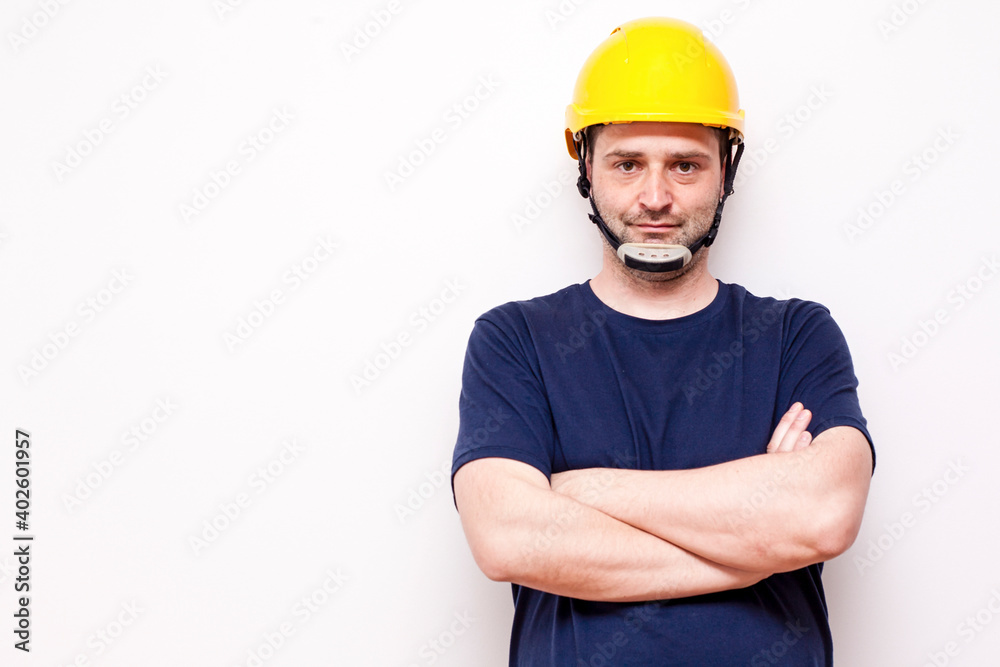 Constraction worker behind white background. Wearing green mask and yellow helmet