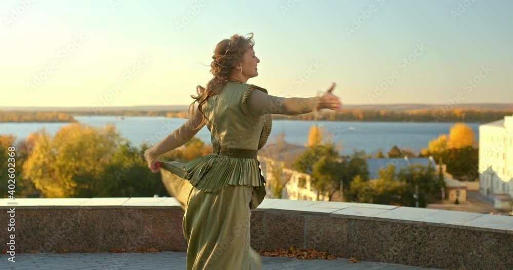 Beautiful young woman is whirling in the street in a smart dress. Happy woman having fun in the street, smiling and spinning in a dress. 4k, ProRes Beautiful young woman is whirling in the street in a smart dress. Happy woman having fun in the street, smiling and spinning in a dress. 4k, ProRes