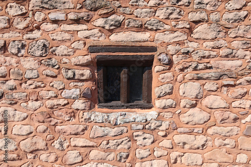 An interesting old window in a stone wall in the village of Nether Stowey in Somerset, United Kingdom