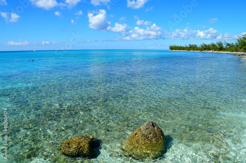 Crystal clear water with corals along the shallow bay at Princess Cays, Bahamas