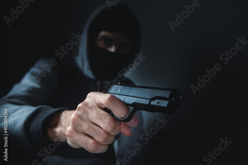 man holds a gun in his hands and threatens
