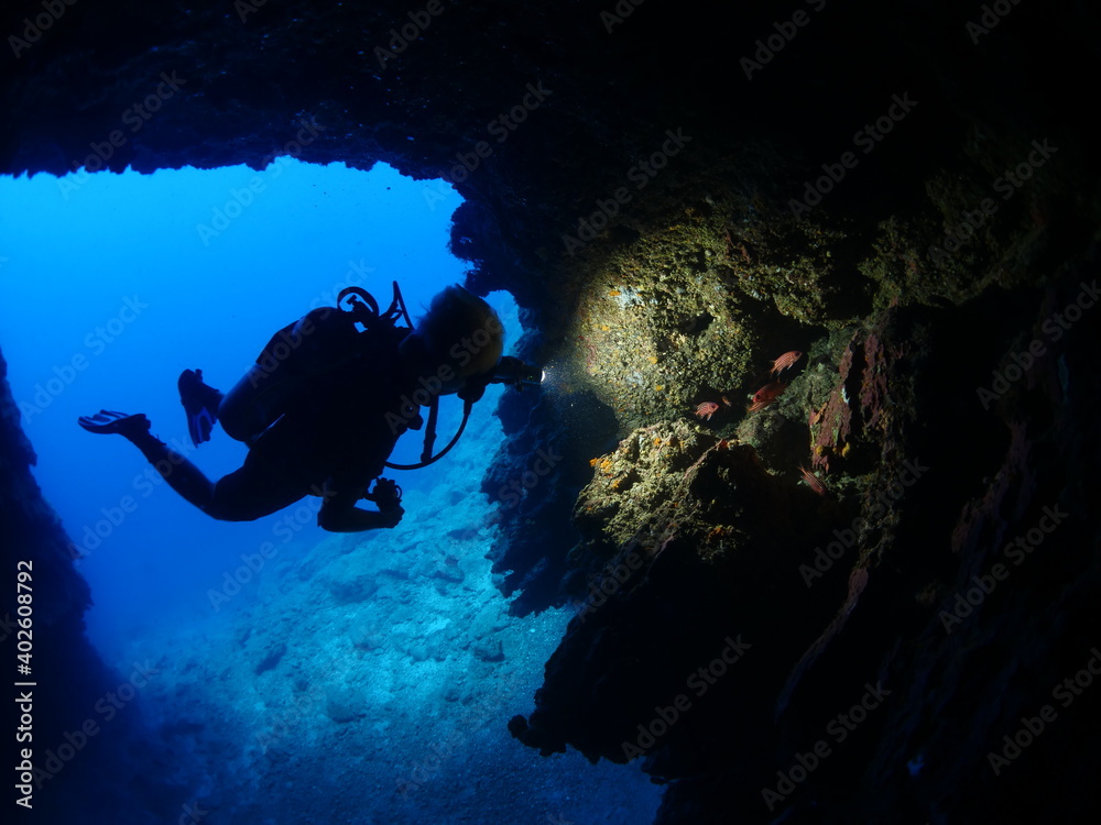 custom made wallpaper toronto digitalScuba divers underwater exploring lightcaves blue ocean scenery with torch