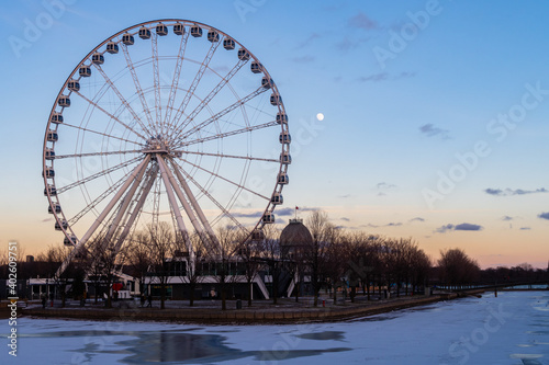 Montreal, Canada - May 2020 : Ferris wheel in the old port with the full moon in the background