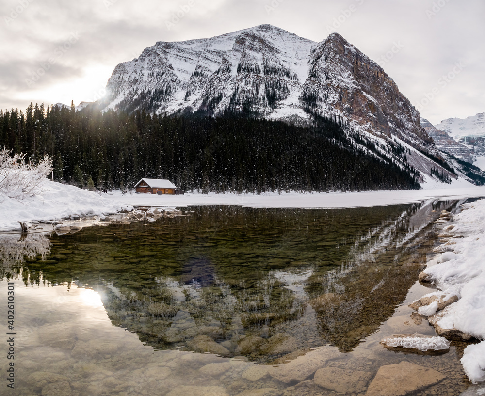 Fototapeta premium Beautiful winter view of a wooden cabin at Lake Louise, Canada