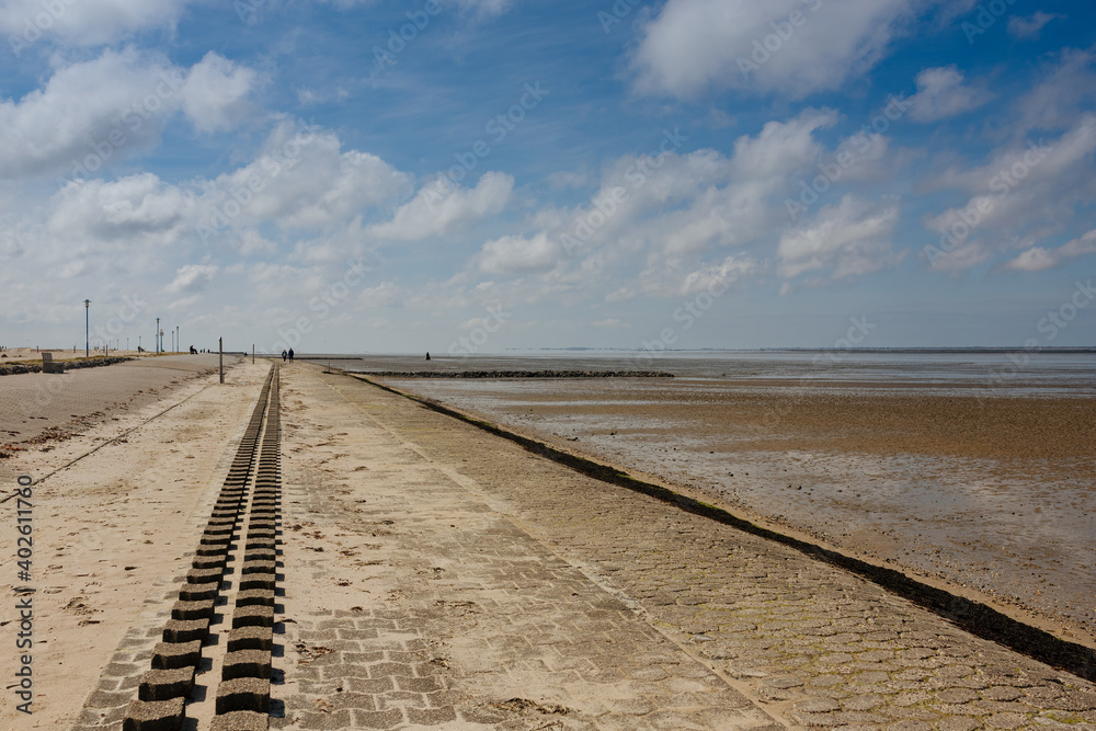 paved beach on the North Sea, at low tide. Promenade on the beach