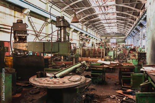 An abandoned old large industrial hall is waiting for demolition, an Industrial machine for metal processing, A former Khabarovsk plant for the production of a diesel engine.