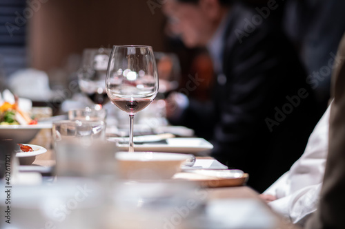 Glass of wine on the table for a company party in a fine dining restaurant at night