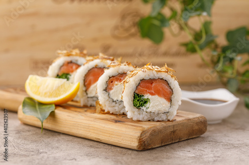 Sushi rolls with tuna shavings on a textured still life background. Restaurant concept. Close-up.