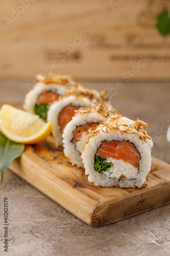 Sushi rolls with tuna shavings on a textured still life background. Restaurant concept. Close-up.