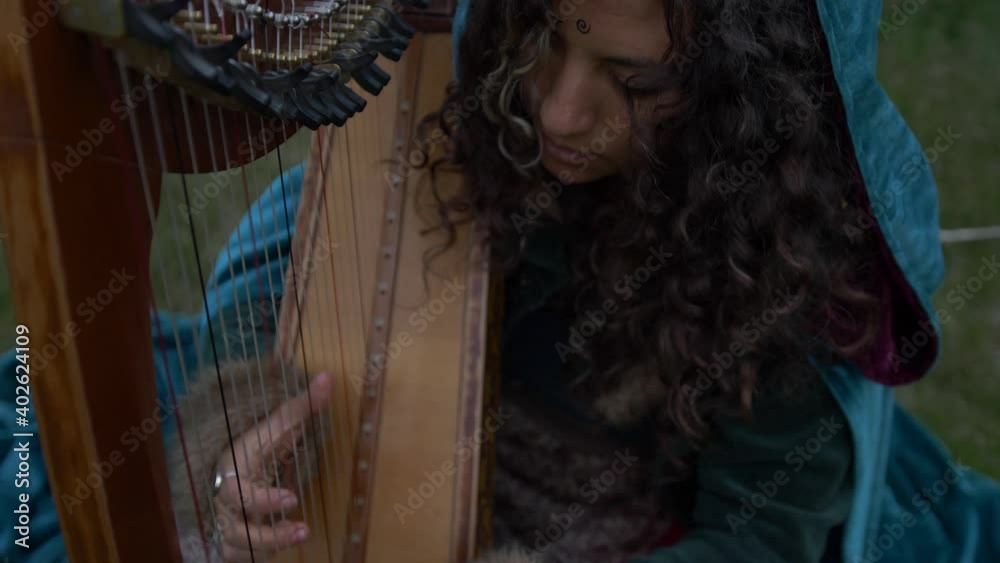 Woman Using a Robe, playing the Harp