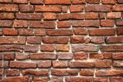 Fragment of a wall of the old building with handwork bricks. Original background.