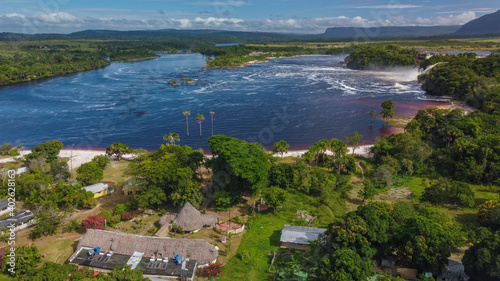 Aerial photography of the entire Canaima Lagoon, surrounded by houses and inns and with its waterfalls. photo
