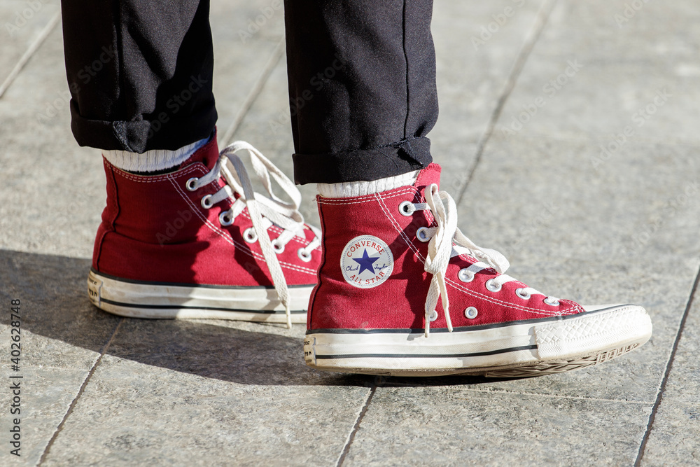 kit Bange for at dø operation Lviv, Ukraine - December 27, 2020. Person wearing red pair of Converse  Chuck Taylor All Stars on the street. Stock Photo | Adobe Stock