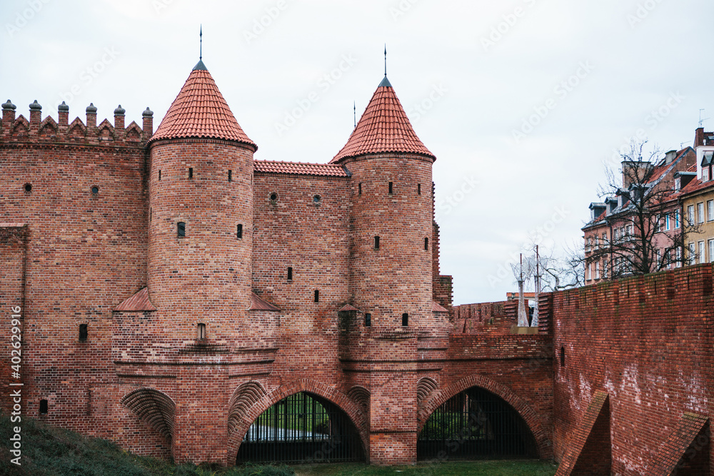 View of the walls of the ancient castle at the entrance to the old town and the town square in Warsaw in Poland. One of the old attractions.