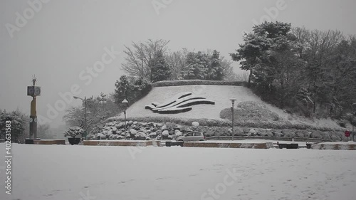 View of snow on ground and trees in a public park during winter