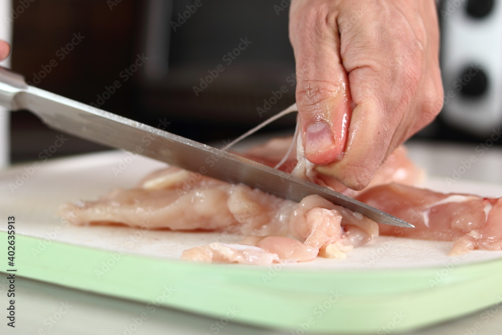 Chef removing tough membrane from chicken fillet. Making Chicken and Egg Galette Series.