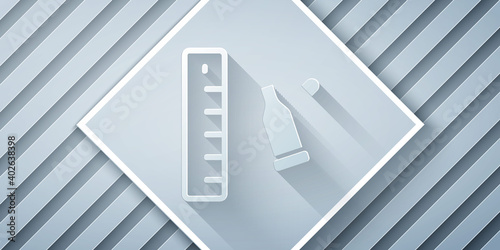 Paper cut Bullet casing as a piece of evidence placed with forensic ruler for documentation icon isolated on grey background. Concept of crime scene. Paper art style. Vector.