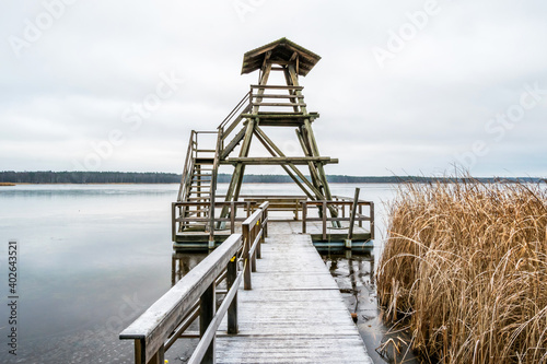 Fototapeta Naklejka Na Ścianę i Meble -  Wooden Rustic Viewing Tower at a Frozen Lake in Latvia