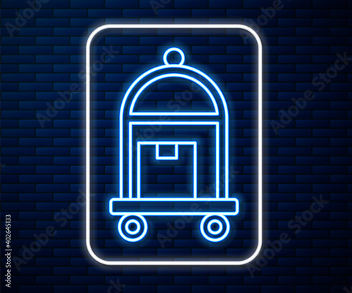 Glowing neon line Hotel luggage cart with suitcase icon isolated on brick wall background. Traveling baggage sign. Travel luggage icon. Vector.