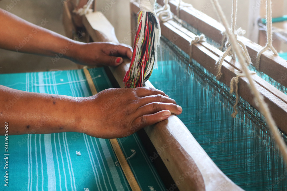 Handloom weaver in India working in her loom Stock Photo | Adobe Stock