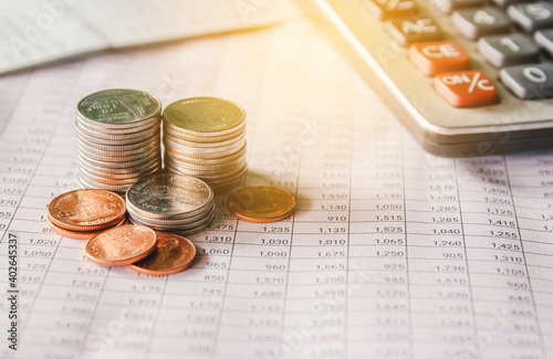 money coin on accounting report sheet background, Saving money or finacial concept.  photo