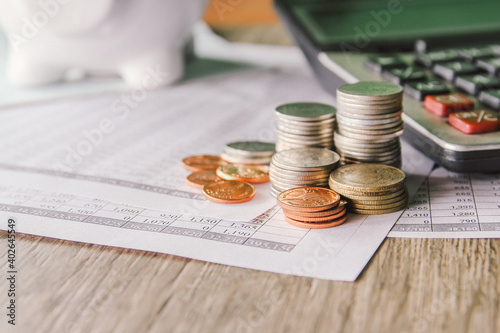 money coin on accounting report sheet background, Saving money or finacial concept.  photo