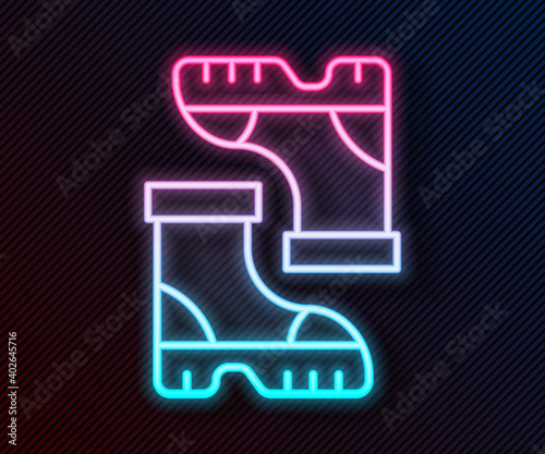 Glowing neon line Waterproof rubber boot icon isolated on black background. Gumboots for rainy weather, fishing, gardening. Vector.