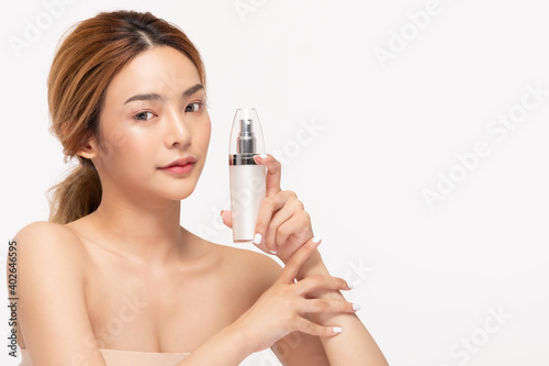 Beauty asian woman hold bottle cosmetic cream lotion and cheerful.
