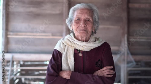 Portrait of Asian senior woman, Older woman with short grey hair standing with crossed arms and looking at camera, Elderly woman concept photo