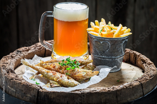 Homemade fried smelt fish with chips and cold beer
