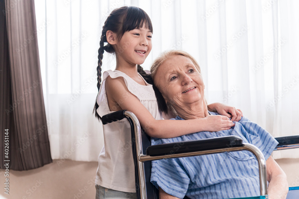 Asian Lovely girl visit and encourage grandmother on patient wheel chair in hospital Asian Lovely girl visit and encourage grandmother on patient wheel chair in hospital