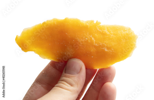 Dried mango in hand isolated on white background.
