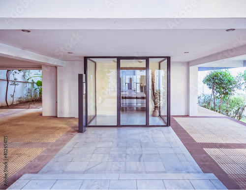 modern apartment building entrance glass and metal door  central perspective