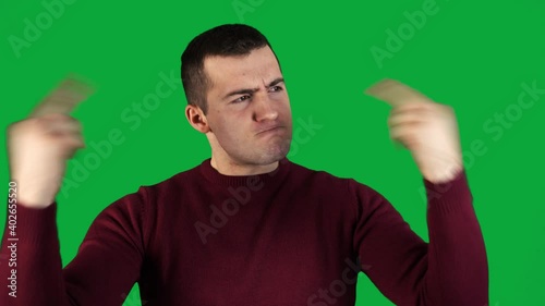 man showing bad gesture with fingers on green background