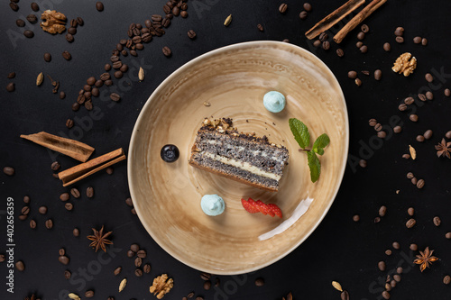 slice of cacke in beautiful plate on the table decorated with coffee beans photo