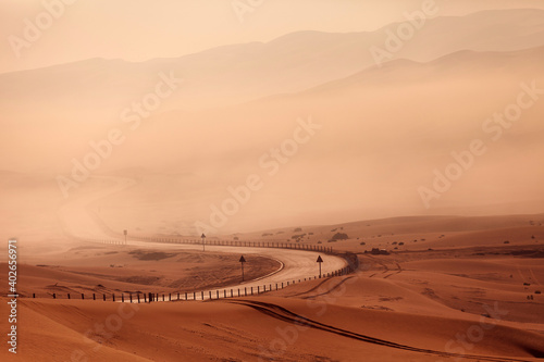 Fototapeta Naklejka Na Ścianę i Meble -  Winding empty road in the desert in foggy weather