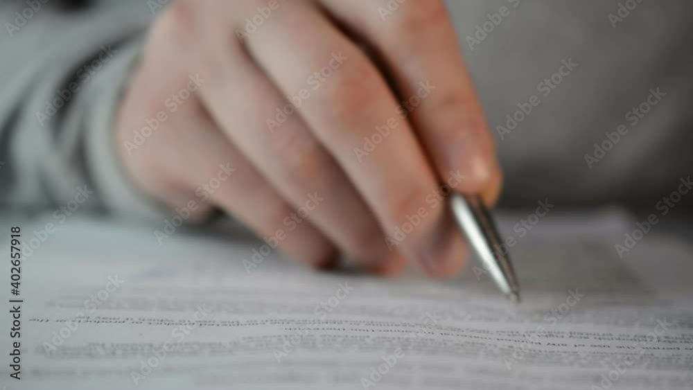 Businessman carefully reads and checks the document close Businessman carefully reads and checks the document close