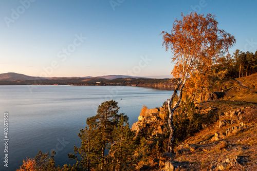 Beautiful lake and rocky shore on a clear sunny day of golden autumn