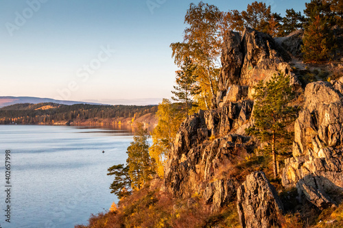 Beautiful lake and rocky shore on a clear sunny day of golden autumn