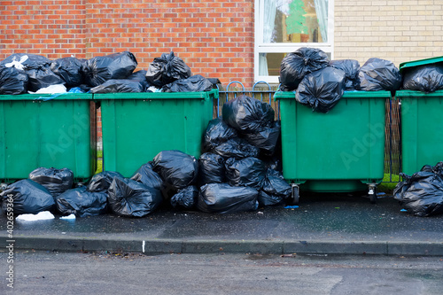 Fly tipping of waste and rubbish black bin bags in residential area