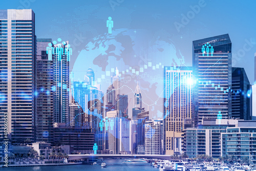 Skyscrapers of Dubai business downtown. International hub of trading and financial services. Social network icons hologram  concept of human resources. Double exposure. Dubai Canal waterfront.