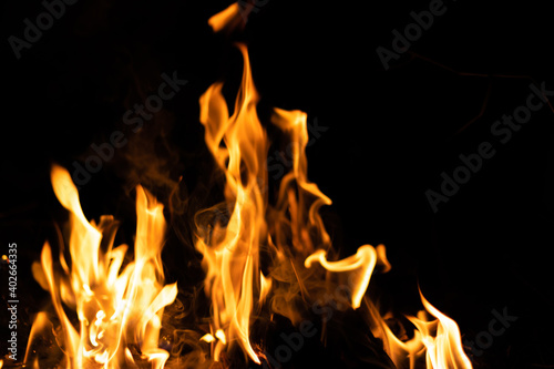 Fire flames on a black background. Abstract fiery texture. Realistic fire flames burn movement frame. Texture for Design. The texture of fire. Fire flames background. Blazing campfire. Sensitive focus