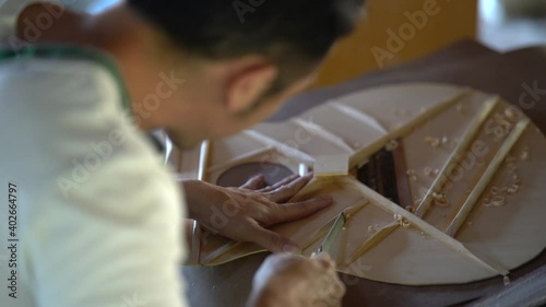 craft man making guitar on wood table, capenter working concept photo