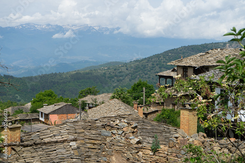 Peaceful villa with mountain in distant. Residential community with antique tradition architectural in Bulgaria. Rural village in countryside at the balkan town. Vintage house and typical design