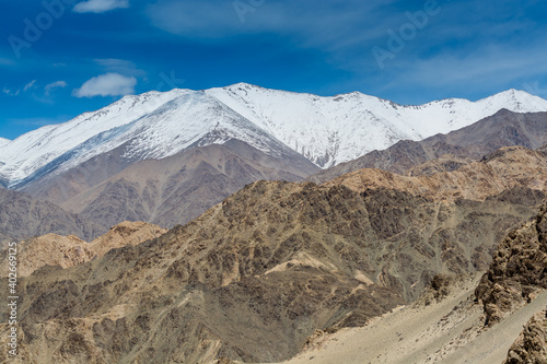 Beautiful landscape of Himalayas barren mountains with white snow, and blue sky, in Ladakh, Kashmir, view from Thiksey Monastery or Thiksey Gompa.