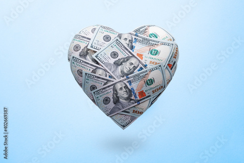 Heart shaped made with 100 dollar banknotes. Happy Valentine's day symbol. Love money concept photo