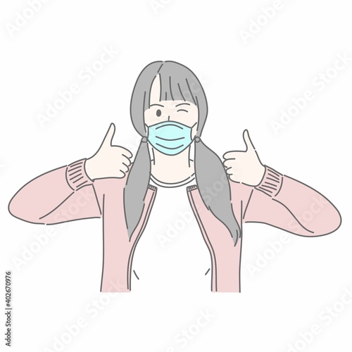 Girl wearing medical mask and gesturing thumb ups.